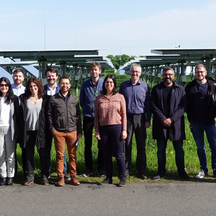 The participants of the technical tour in front of the heliostat field of DLR's Solar Towers Jülich.